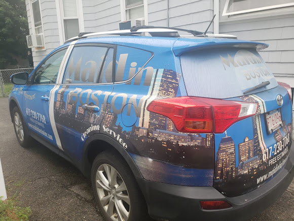 Rear angle of Maid In Boston's real blue wrapped service vehicle